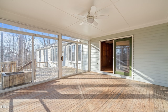 unfurnished sunroom with a ceiling fan