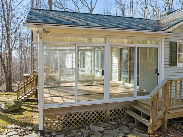 wooden deck with stairs and a sunroom