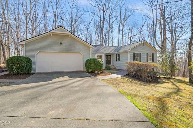 ranch-style home featuring a front lawn, a garage, and driveway