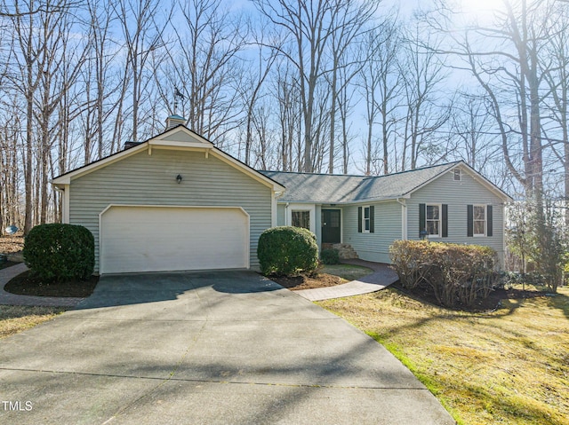 single story home with a garage and driveway