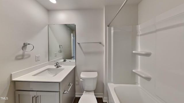 bathroom with toilet, vanity, and washtub / shower combination