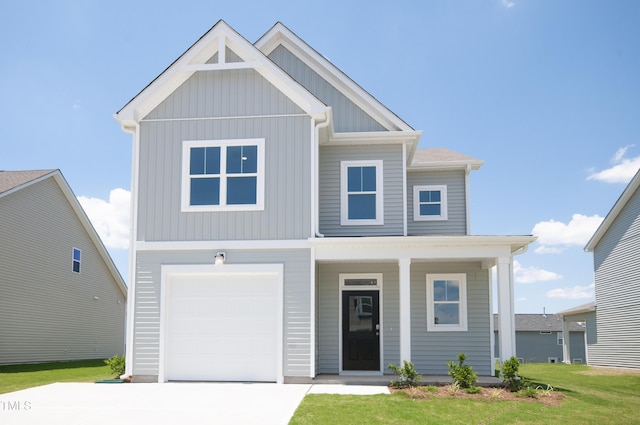 view of front of property with a front yard, a porch, concrete driveway, a garage, and board and batten siding