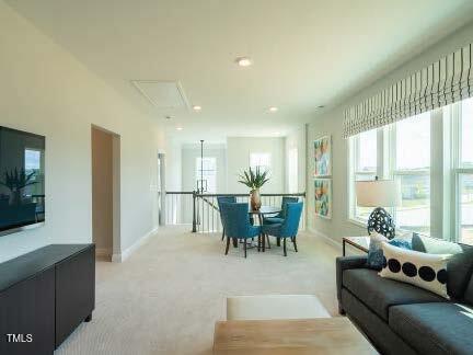 living room with baseboards and light carpet