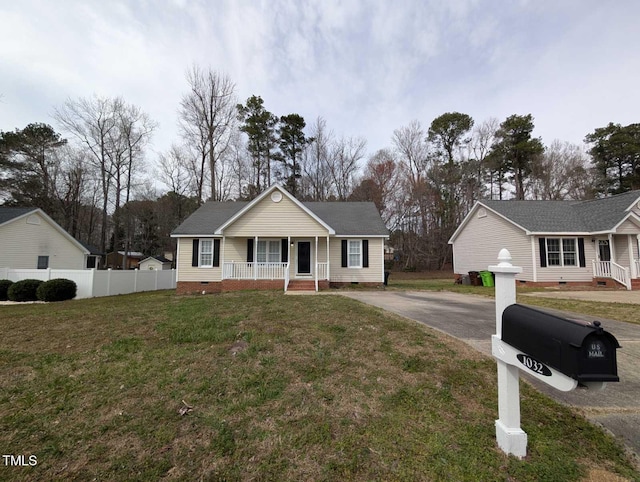 view of front of property featuring a front yard, fence, driveway, covered porch, and crawl space