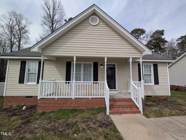 bungalow-style home with crawl space, a porch, and a shingled roof