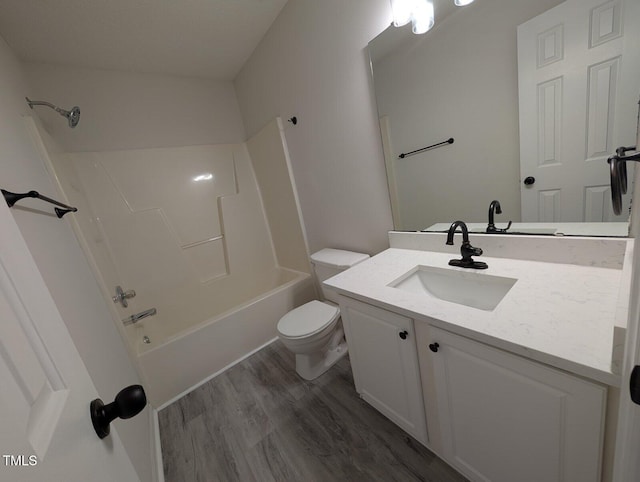 bathroom with vanity,  shower combination, toilet, and wood finished floors