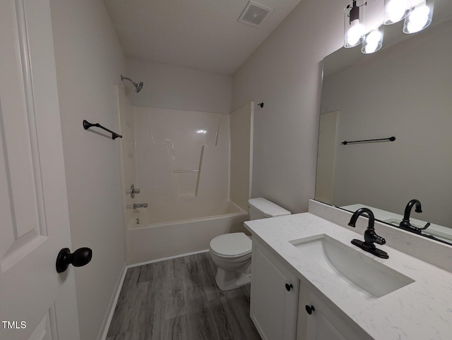 full bathroom featuring visible vents, toilet, bathtub / shower combination, wood finished floors, and vanity