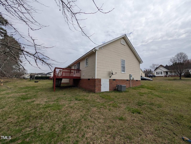 view of side of home featuring crawl space, a yard, and a wooden deck