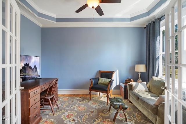 office space featuring wood finished floors, french doors, crown molding, baseboards, and ceiling fan