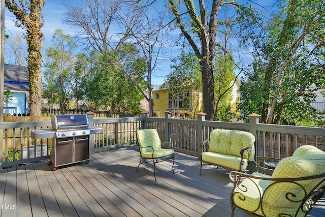 wooden terrace featuring a grill and fence