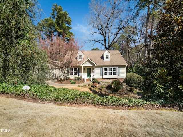 new england style home featuring a garage