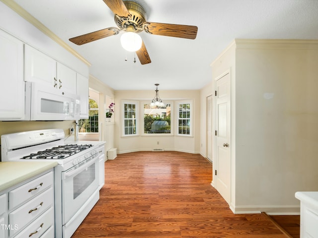 kitchen featuring a ceiling fan, wood finished floors, white cabinetry, white appliances, and light countertops