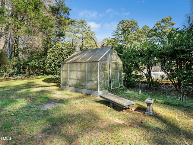 view of greenhouse featuring a lawn