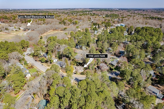 aerial view featuring a wooded view