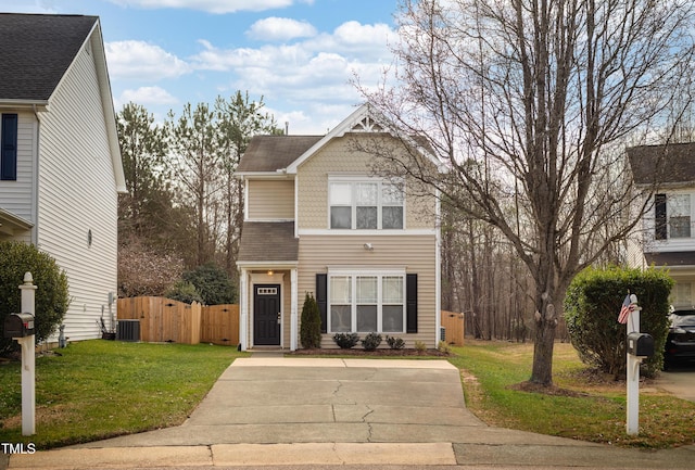 view of front of house featuring central air condition unit, a front yard, and fence