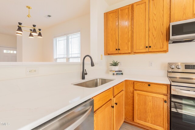 kitchen with visible vents, appliances with stainless steel finishes, light countertops, and a sink