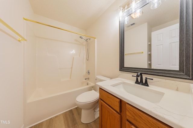 bathroom featuring visible vents, toilet, bathtub / shower combination, wood finished floors, and vanity