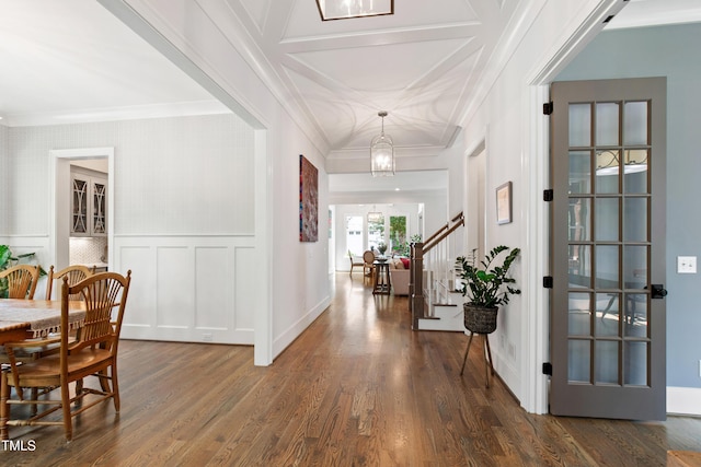 3337 Cheswick Dr, Raleigh, NC 27609 - entryway featuring ornamental molding, dark wood-style flooring, stairs, coffered ceiling, and a decorative wall