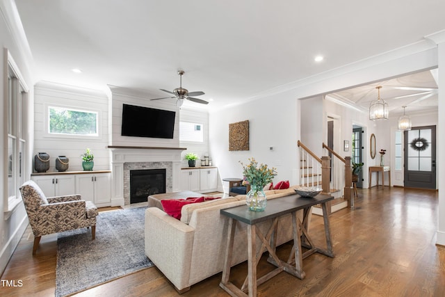 3337 Cheswick Dr, Raleigh, NC 27609 - living room featuring ornamental molding, wood finished floors, ceiling fan, a fireplace, and stairway