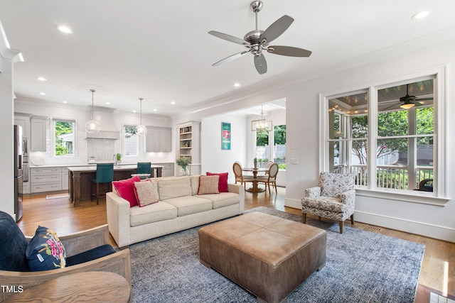 3337 Cheswick Dr, Raleigh, NC 27609 - living area featuring ceiling fan, light wood finished floors, crown molding, and recessed lighting