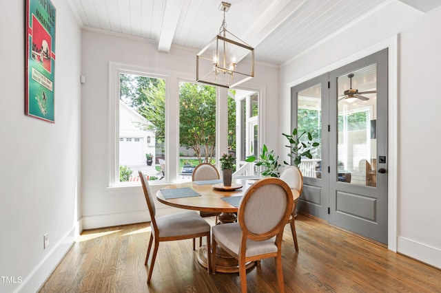3337 Cheswick Dr, Raleigh, NC 27609 - dining area featuring a chandelier, wood finished floors, and a wood ceiling with exposed beams