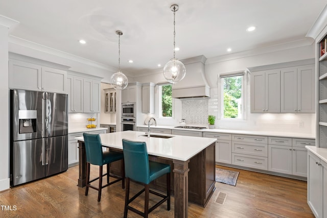 3337 Cheswick Dr, Raleigh, NC 27609 - kitchen featuring stainless steel appliances, custom exhaust hood, tasteful backsplash, a center island with sink, and light countertops