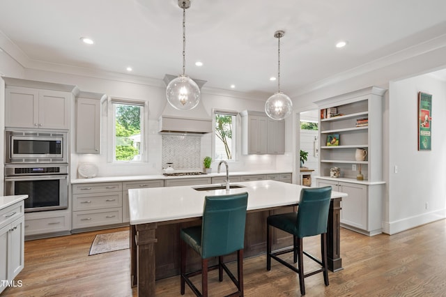 3337 Cheswick Dr, Raleigh, NC 27609 - kitchen with appliances with stainless steel finishes, light countertops, backsplash, open shelves, and an island with sink
