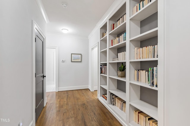 3337 Cheswick Dr, Raleigh, NC 27609 - hallway featuring wood finished floors, ornamental molding, and built in shelves