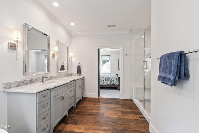 3337 Cheswick Dr, Raleigh, NC 27609 - bathroom with double vanity, wood finished floors, a shower stall, ornamental molding, and recessed lighting