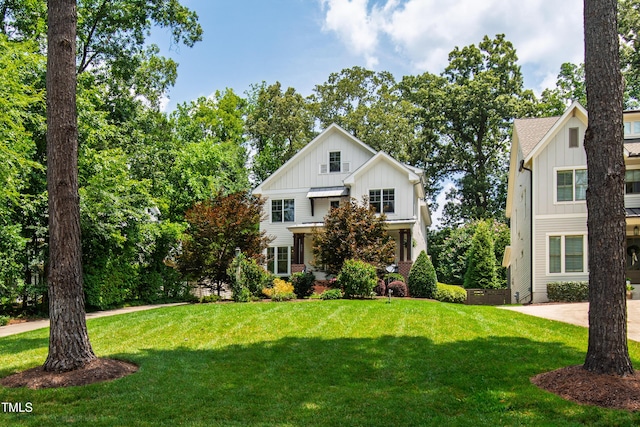3337 Cheswick Dr, Raleigh, NC 27609 - modern farmhouse style home featuring board and batten siding and a front lawn