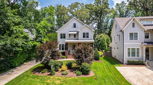 3337 Cheswick Dr, Raleigh, NC 27609 - modern farmhouse style home with board and batten siding, a standing seam roof, a front lawn, and covered porch