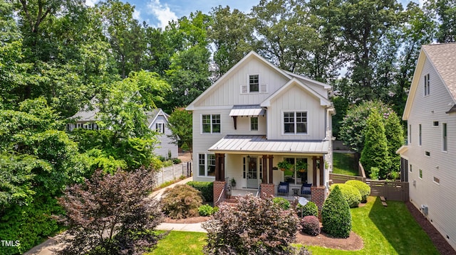 3337 Cheswick Dr, Raleigh, NC 27609 - modern farmhouse featuring board and batten siding, covered porch, a standing seam roof, a metal roof, and view of scattered trees