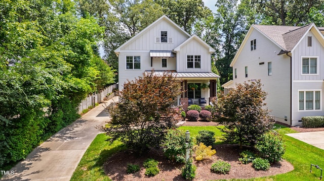 3337 Cheswick Dr, Raleigh, NC 27609 - modern inspired farmhouse featuring board and batten siding, covered porch, a standing seam roof, and a metal roof