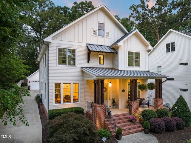 3337 Cheswick Dr, Raleigh, NC 27609 - modern inspired farmhouse with a porch, board and batten siding, a standing seam roof, and a metal roof