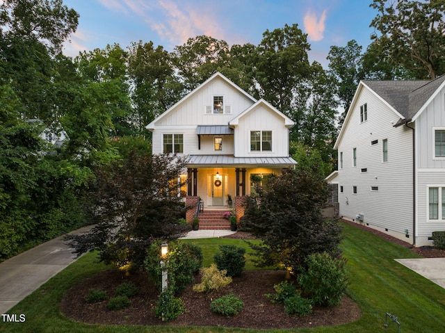 3337 Cheswick Dr, Raleigh, NC 27609 - modern inspired farmhouse with a standing seam roof, a porch, board and batten siding, a front lawn, and a metal roof