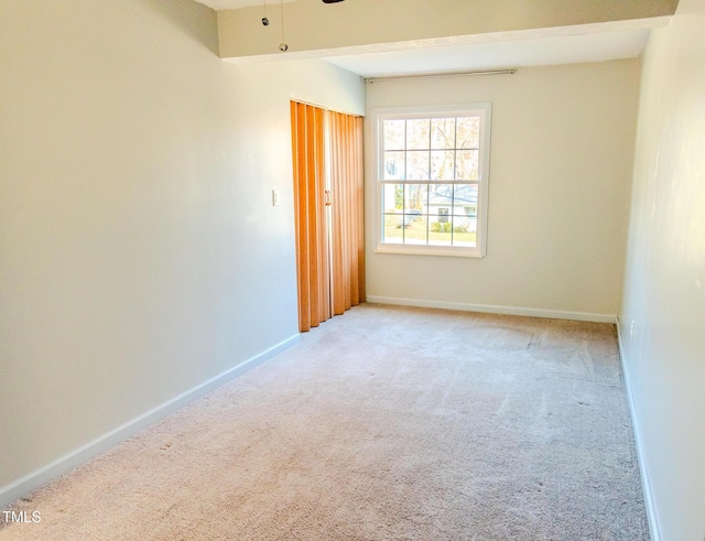 empty room with ceiling fan, baseboards, and carpet floors