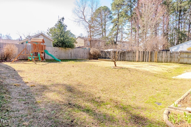 view of yard with a playground and a fenced backyard