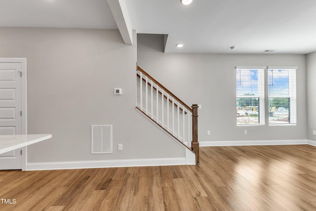 interior space with wood finished floors, visible vents, and baseboards