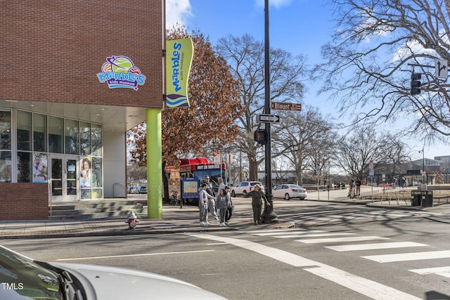 view of street with curbs, street lights, and sidewalks