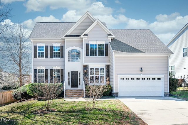 traditional-style home featuring a front lawn, fence, roof with shingles, concrete driveway, and a garage