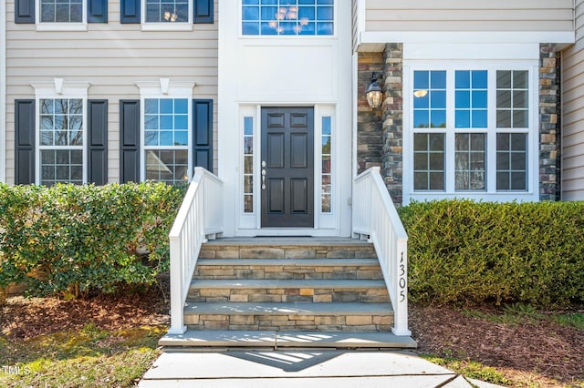 doorway to property featuring stone siding