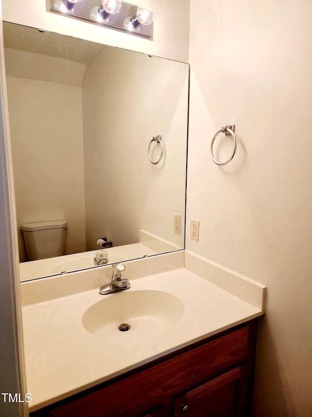 half bath with vanity and toilet