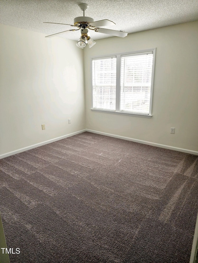 spare room with baseboards, a textured ceiling, carpet floors, and ceiling fan