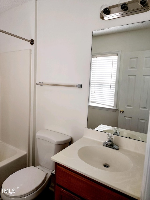 bathroom with toilet and vanity