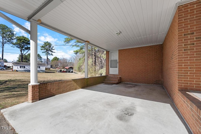 view of patio / terrace with a carport and entry steps