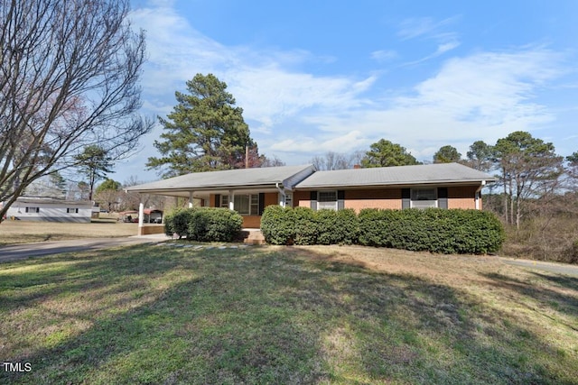 single story home with a carport, a porch, and a front yard