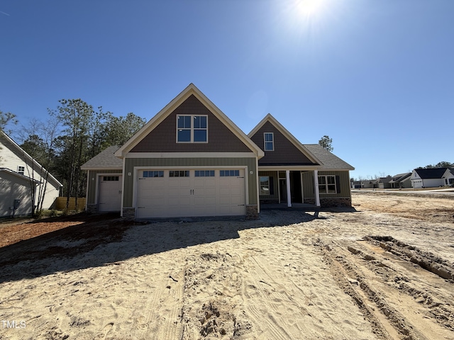 view of front facade featuring driveway and roof with shingles