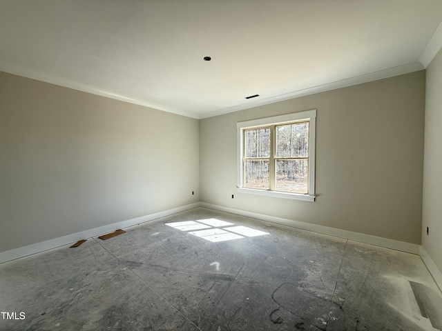 empty room featuring visible vents, baseboards, and ornamental molding