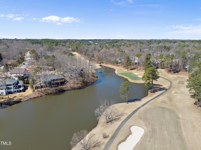 drone / aerial view featuring a water view and a wooded view