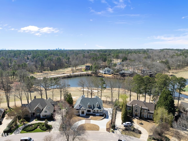 bird's eye view with a forest view and a water view